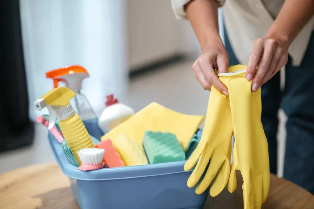 close up picture female hands taking off gloves